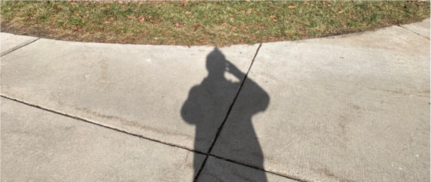Aron taking a photo of his shadow.